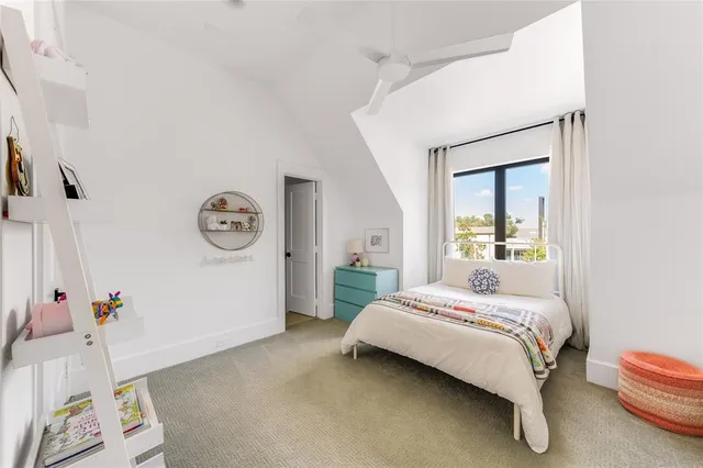 a bedroom with a bed couch and window