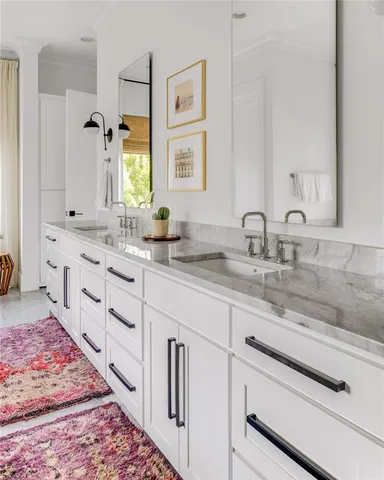 a bathroom with double sink and a mirror
