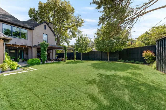 a view of a house with a yard and sitting area