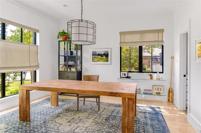 a living room with dining table and a window