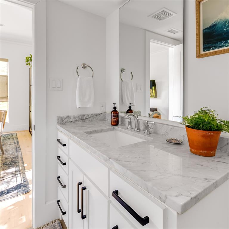 6905 Northridge Drive Dallas, TX 75214 - Photo 6 of 35 a bathroom with sink and mirror
