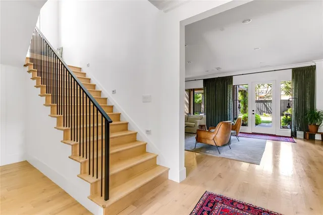a view of staircase with wooden floor and windows
