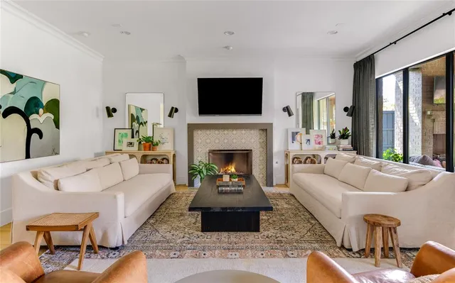 a living room with furniture fireplace and flat screen tv