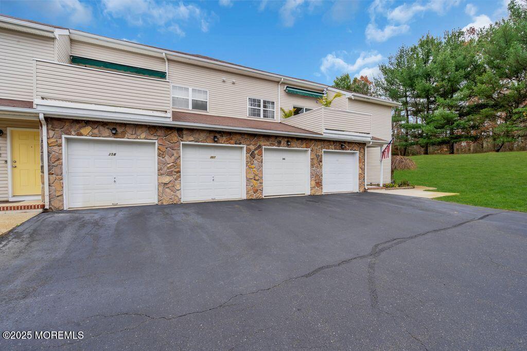 357 Volley Court Wall, NJ 07719 - Photo 18 of 19 a view of a house with a yard and garage