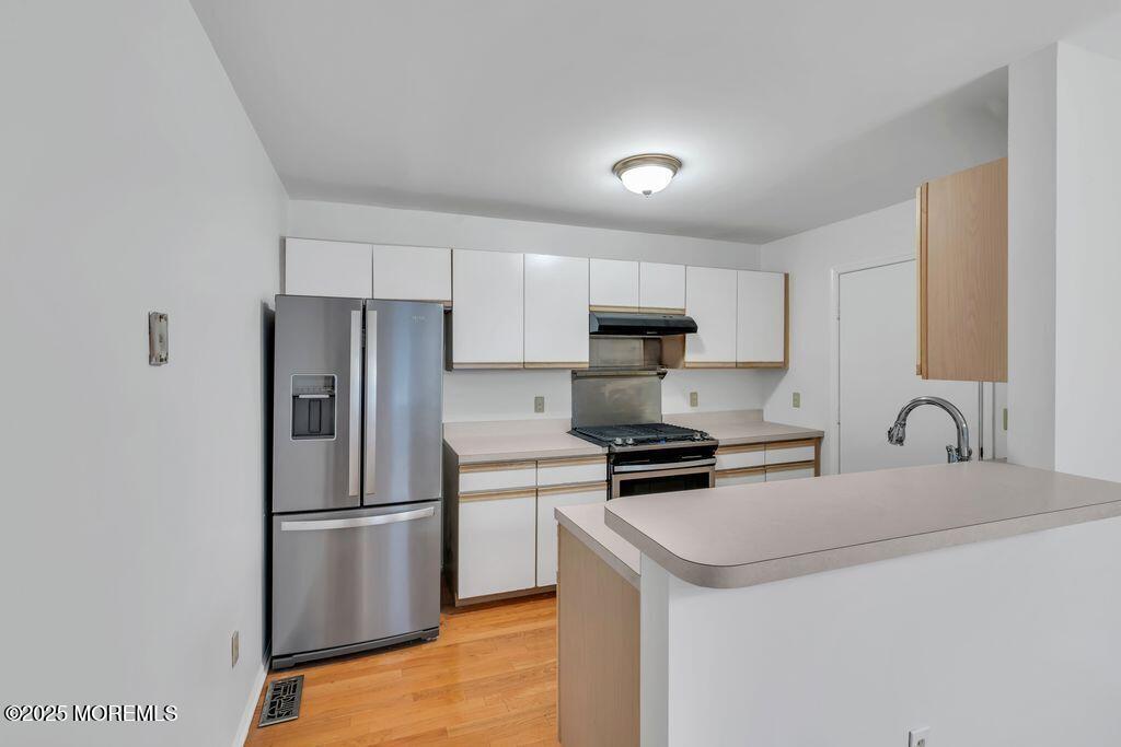 357 Volley Court Wall, NJ 07719 - Photo 6 of 19 a kitchen with stainless steel appliances a refrigerator a sink a stove a microwave and island