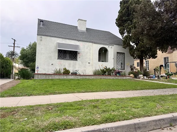 a front view of house with yard and outdoor seating