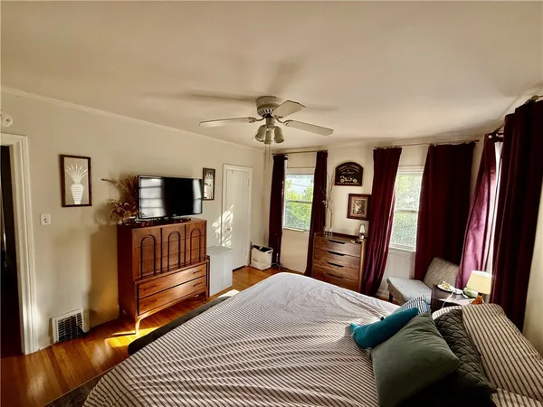 a bedroom with furniture and a flat screen tv