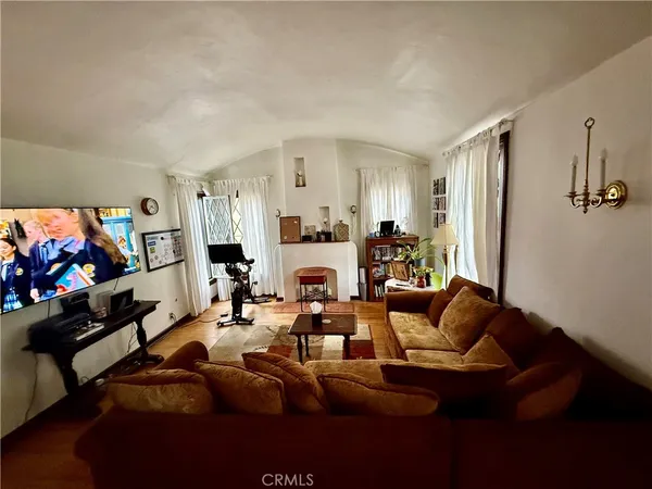 a living room with furniture fireplace and a flat screen tv