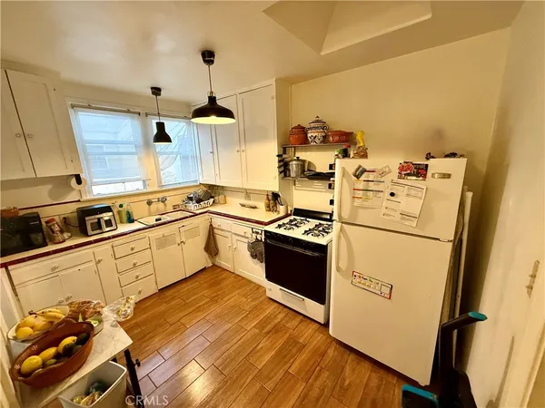 a kitchen with a stove a sink and a refrigerator