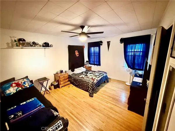 a living room with furniture rug and wooden floor