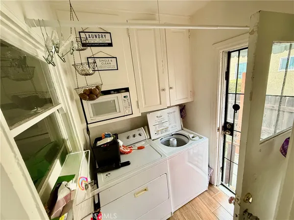 a utility room with multiple dryer and washer