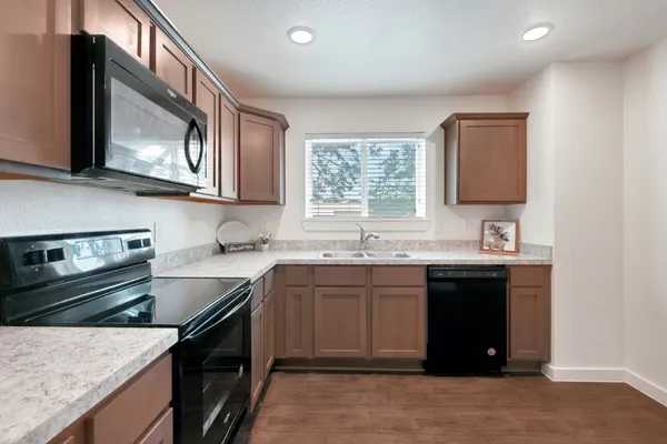 a kitchen with stainless steel appliances granite countertop a sink stove and oven