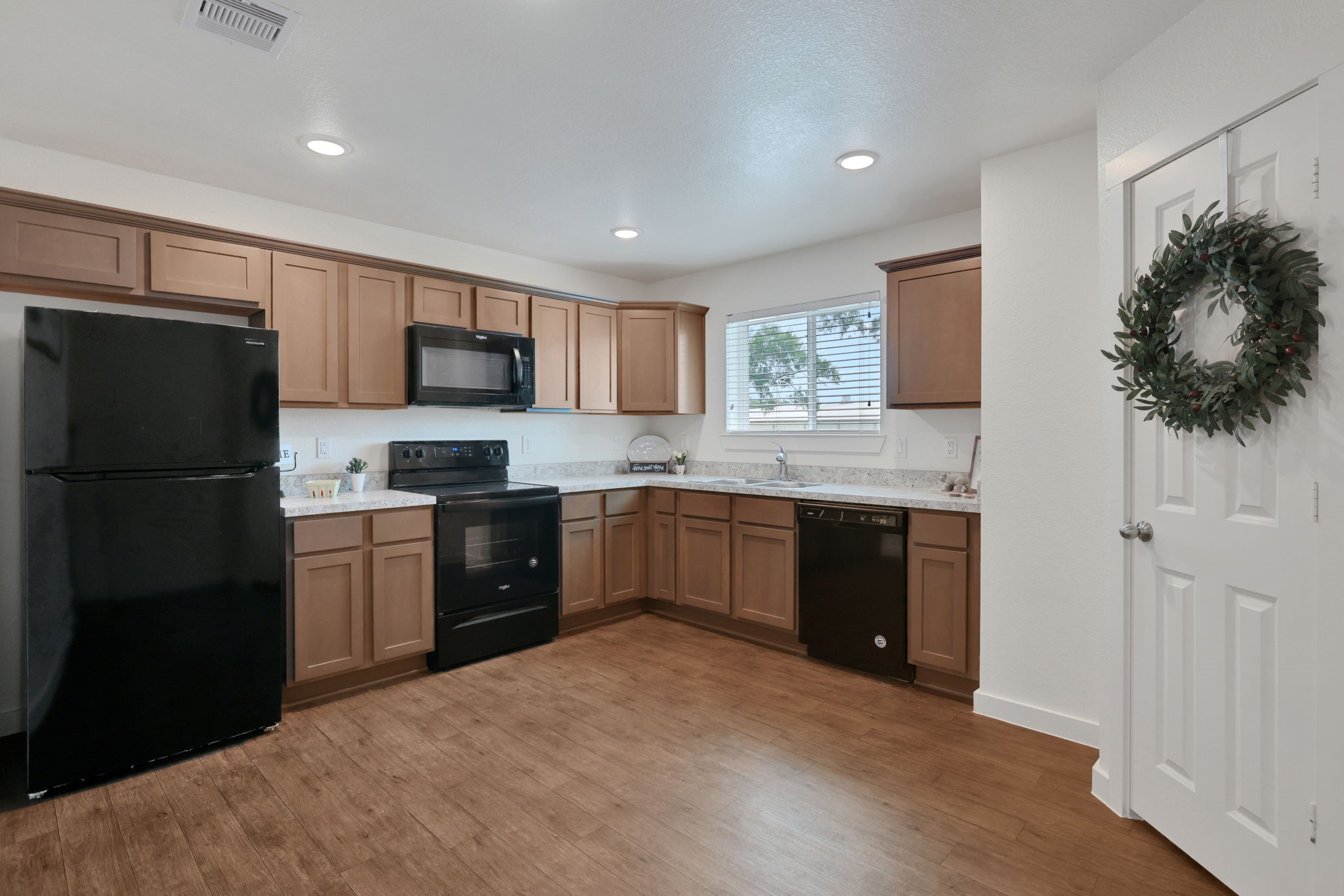 12603 Telge Road, Unit 30CD Cypress, TX 77429 - Photo 9 of 22 a kitchen with a refrigerator and a stove top oven