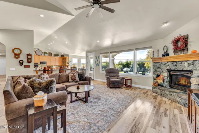 a living room with furniture a fireplace and a flat screen tv