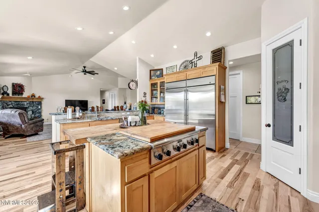 a kitchen with stainless steel appliances granite countertop a refrigerator and a sink