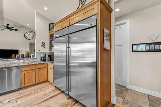 a dining room with furniture large windows and wooden floor