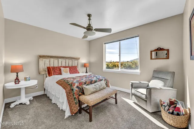 a bathroom with a sink a toilet a mirror a lamp and shower