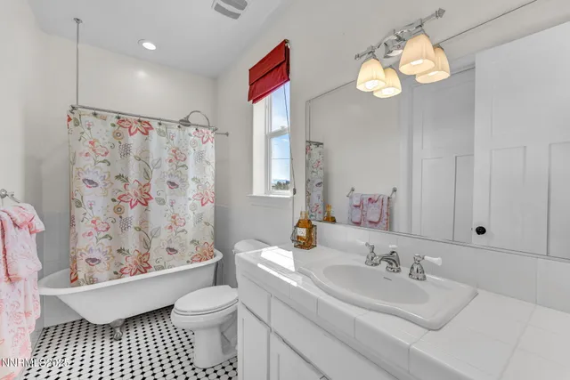 a living room with furniture a chandelier and a piano