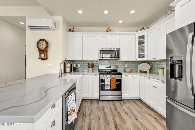 a bedroom with a bed a couch and a large window with the outer view