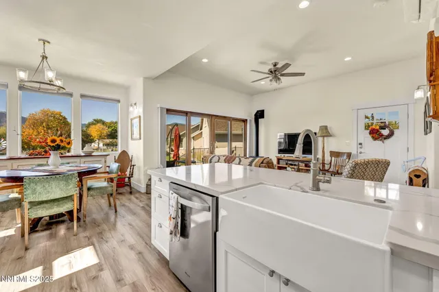 a spacious bathroom with a granite countertop sink mirror and bathtub