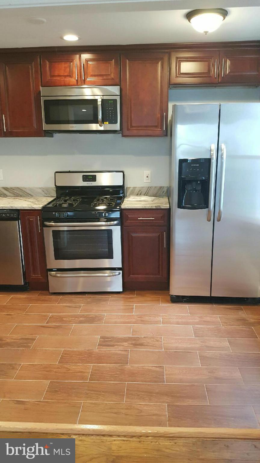 5100 Addison Road Capitol Heights, MD 20743 - Photo 3 of 10 a kitchen with a stove and a microwave