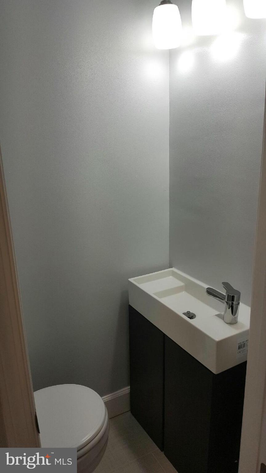 5100 Addison Road Capitol Heights, MD 20743 - Photo 8 of 10 a bathroom with a sink a toilet and vanity