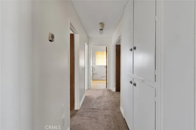 a view of a hallway with wooden shelves