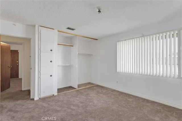 an empty room with a empty space and windows