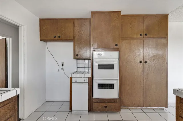 a kitchen with cabinets and white appliances