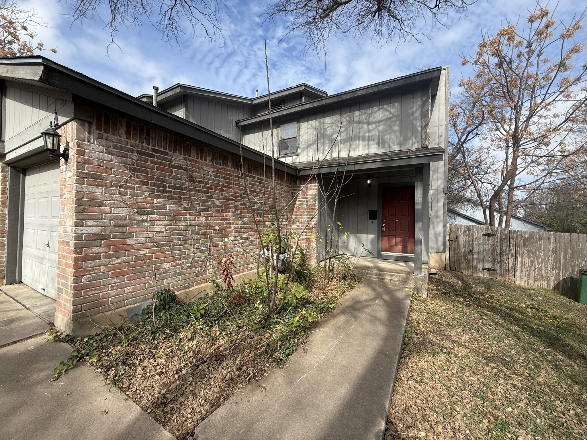 Property entrance with a garage and brick siding