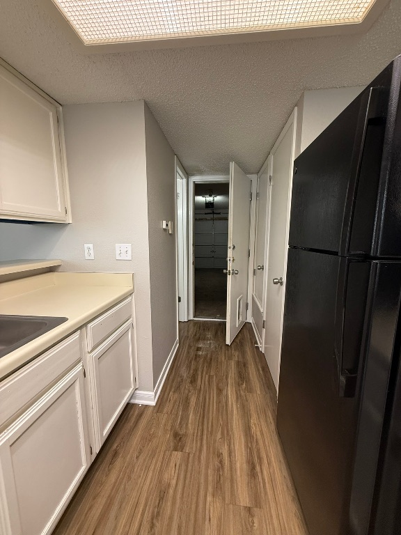 7806 Topawa Cove, Unit A Austin, TX 78729 - Photo 11 of 25 a kitchen with a refrigerator a sink and dishwasher