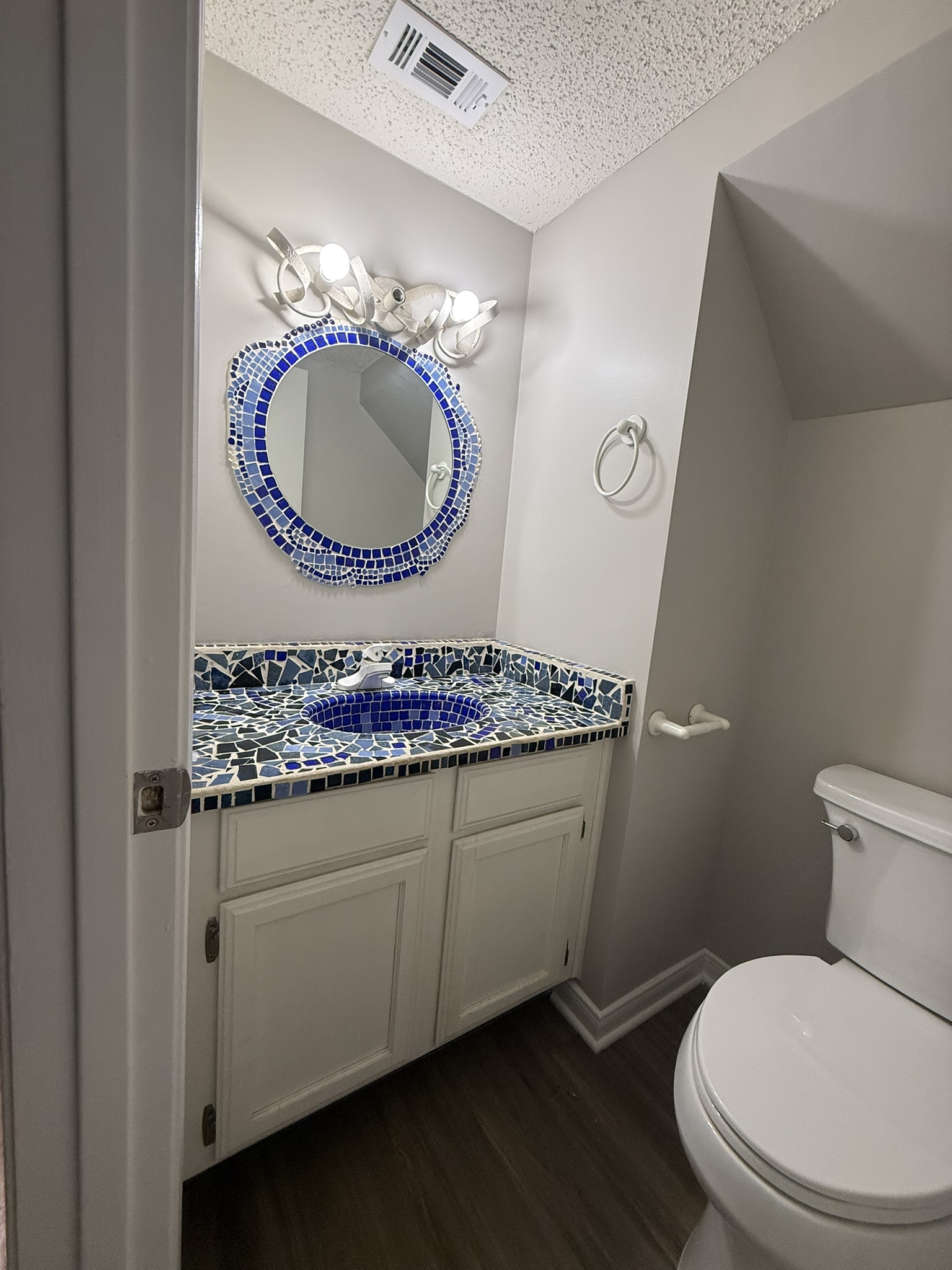 7806 Topawa Cove, Unit A Austin, TX 78729 - Photo 12 of 25 Half bathroom featuring vanity, dark wood-type flooring, and a textured ceiling
