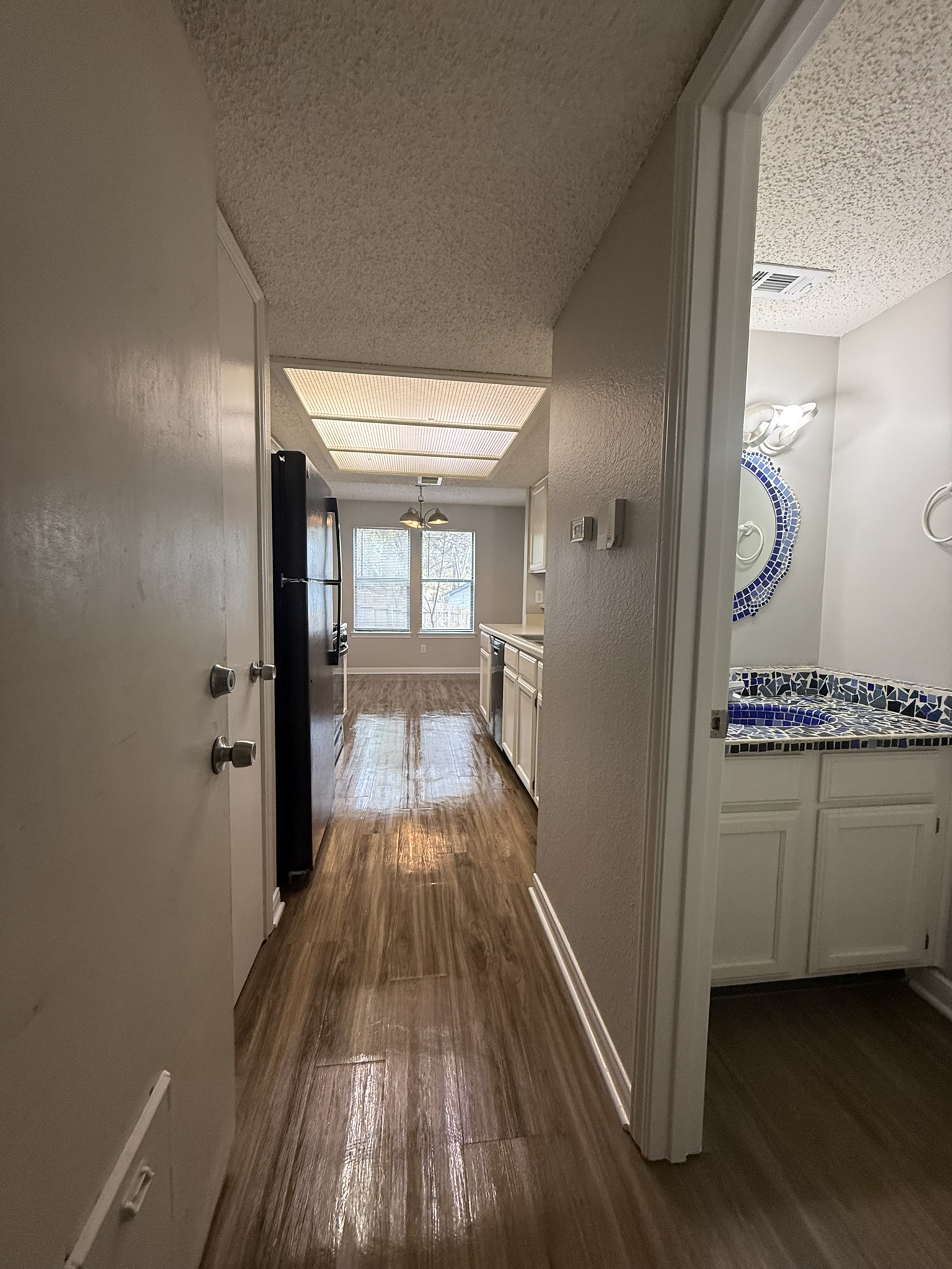 7806 Topawa Cove, Unit A Austin, TX 78729 - Photo 13 of 25 Corridor with dark wood finished floors and a textured ceiling