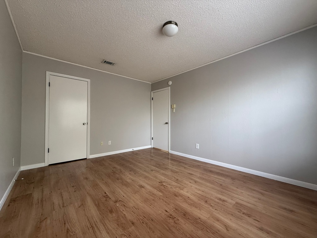 7806 Topawa Cove, Unit A Austin, TX 78729 - Photo 21 of 25 a view of an empty room with wooden floor