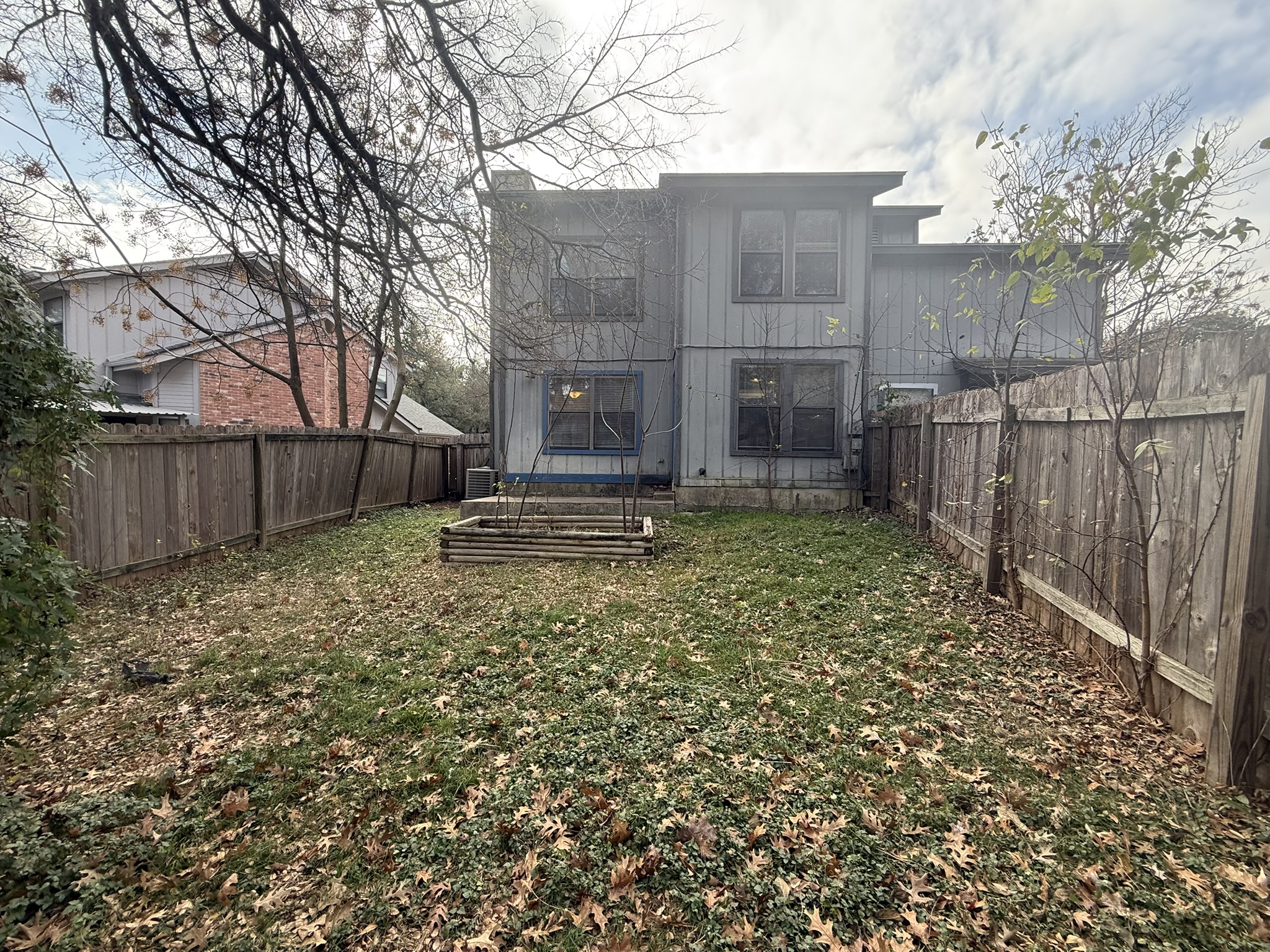 7806 Topawa Cove, Unit A Austin, TX 78729 - Photo 25 of 25 Rear view of property with a fenced backyard and a trampoline