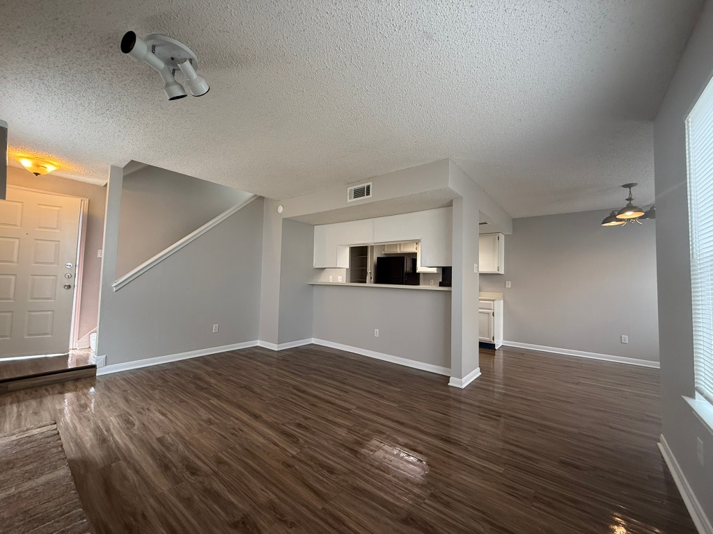 7806 Topawa Cove, Unit A Austin, TX 78729 - Photo 6 of 25 a view of empty room with wooden floor