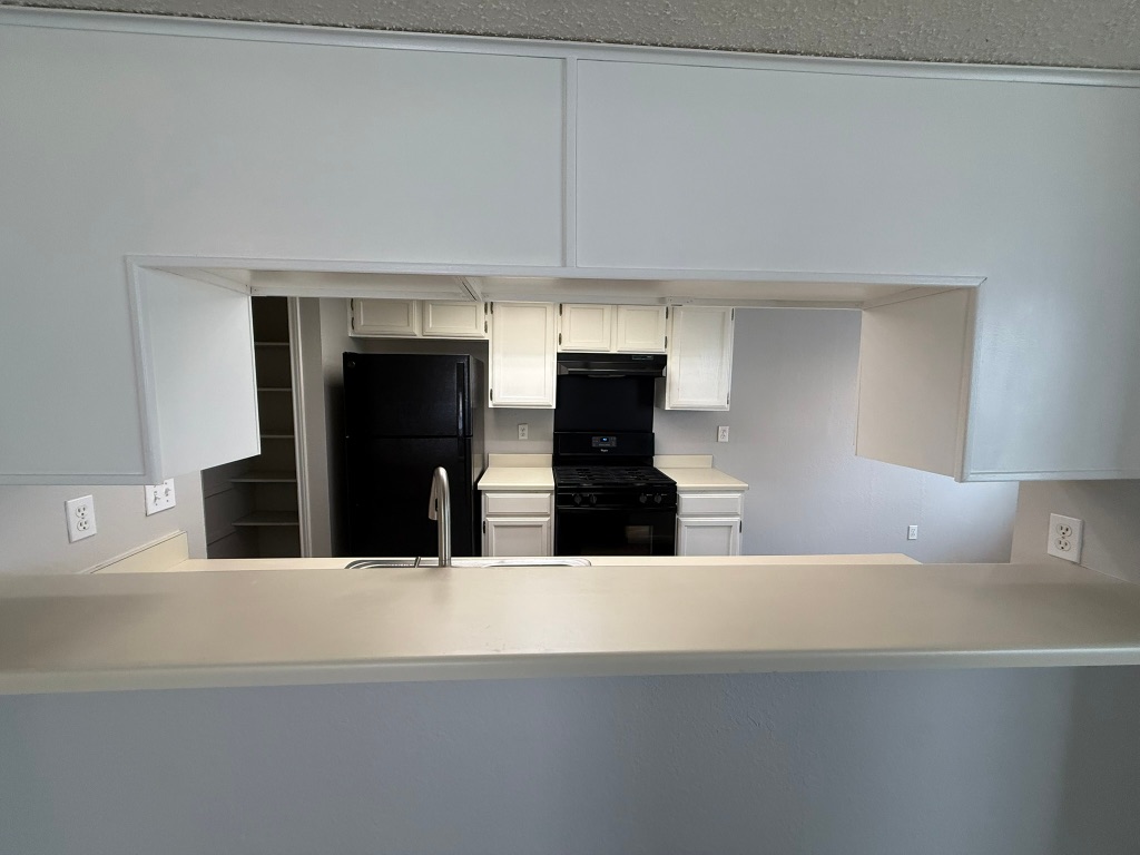 7806 Topawa Cove, Unit A Austin, TX 78729 - Photo 8 of 25 a view of a kitchen with furniture and a kitchen