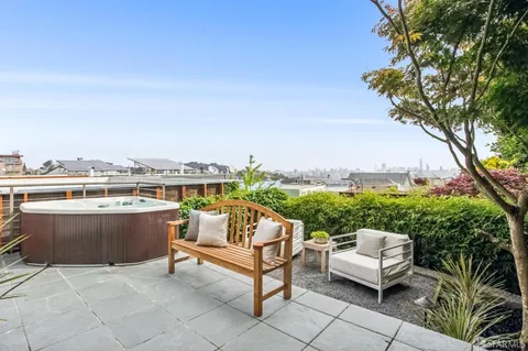 a terrace with outdoor seating and city view