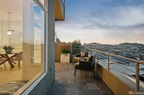 a living room with furniture flat screen tv and outdoor view