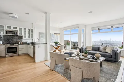 a living room with furniture flat screen tv and large window