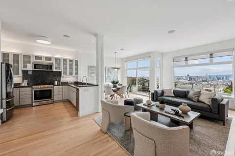 a kitchen with stainless steel appliances granite countertop a refrigerator stove and sink