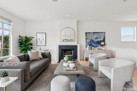 a living room with a stove and a book shelf