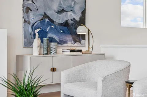 a view of livingroom with a couch and a potted plant