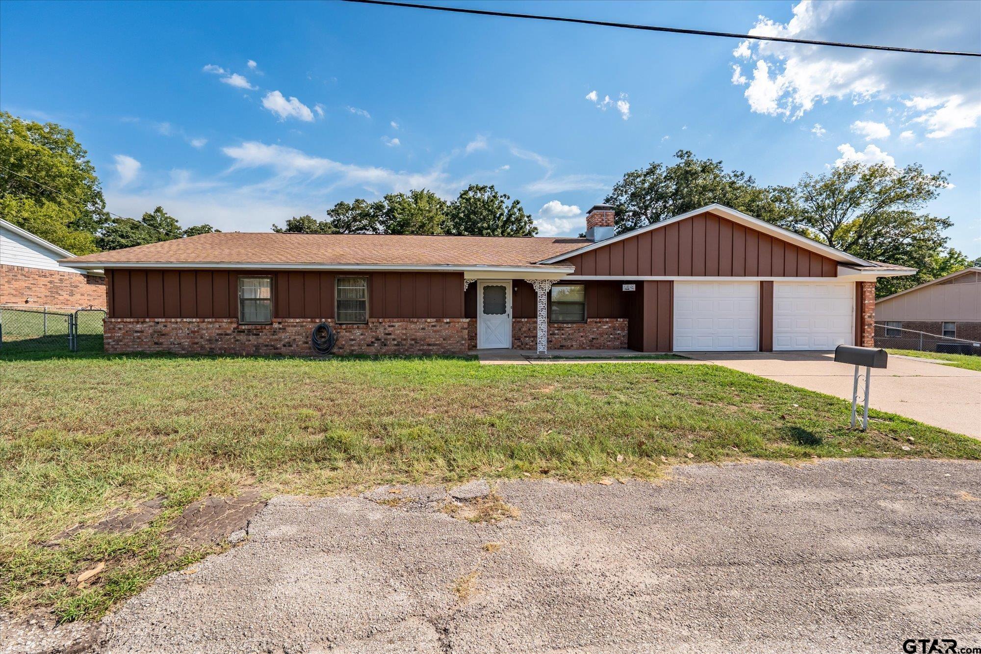 13791 Maple Drive Tyler, TX 75709 - Photo 1 of 26 a front view of a house with garden