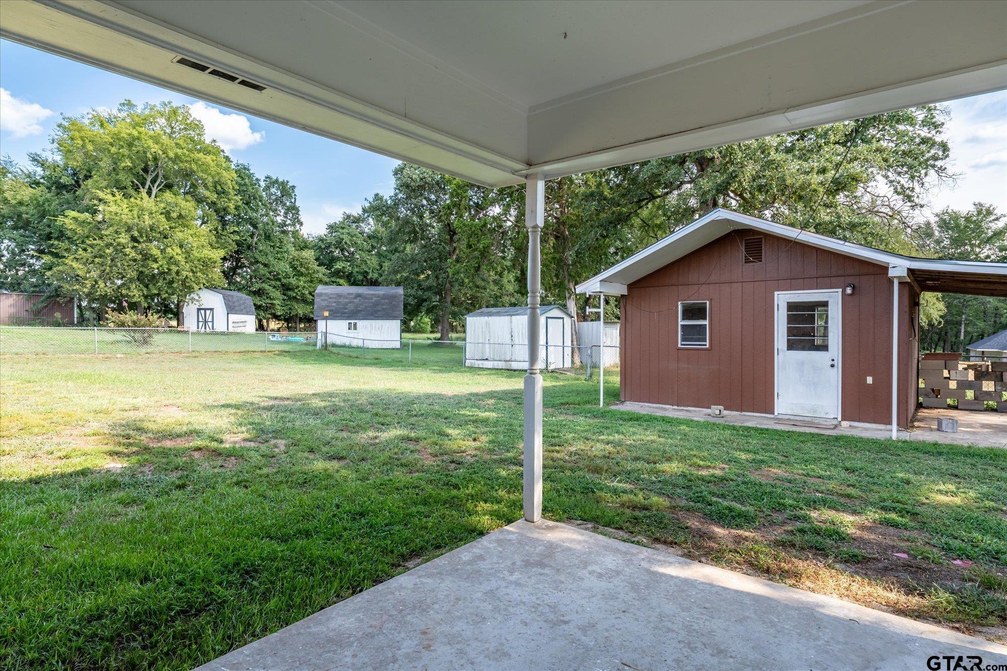 13791 Maple Drive Tyler, TX 75709 - Photo 20 of 26 a view of a house with yard and a garden