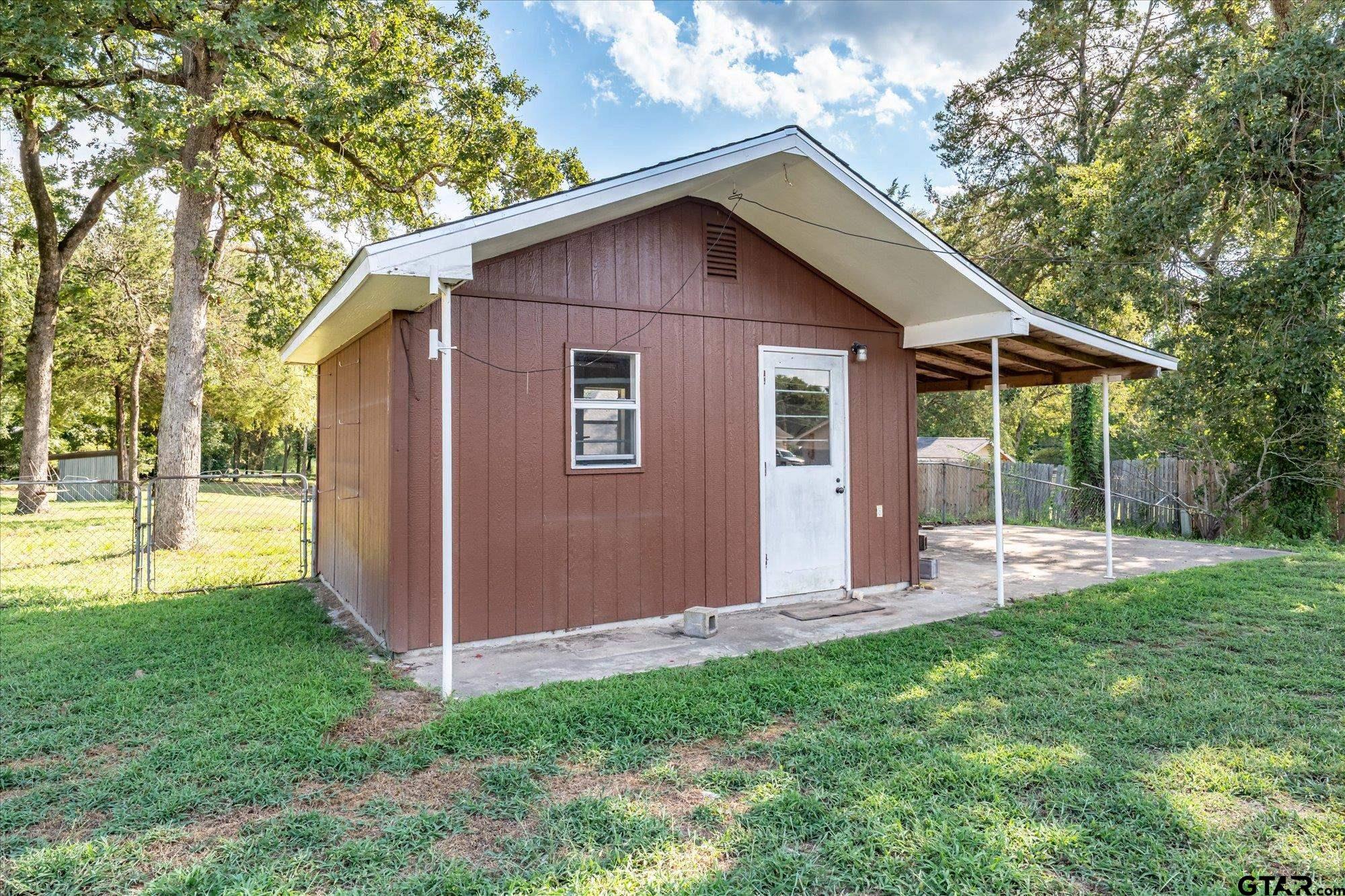 13791 Maple Drive Tyler, TX 75709 - Photo 22 of 26 a view of a house with backyard and garden