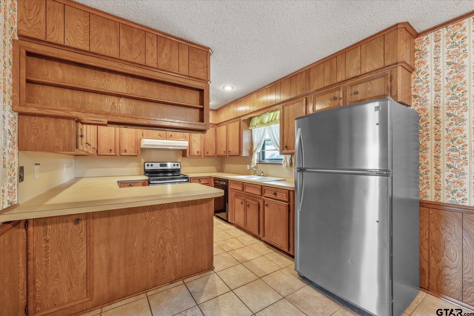 13791 Maple Drive Tyler, TX 75709 - Photo 6 of 26 a kitchen with stainless steel appliances granite countertop a refrigerator a sink and a stove