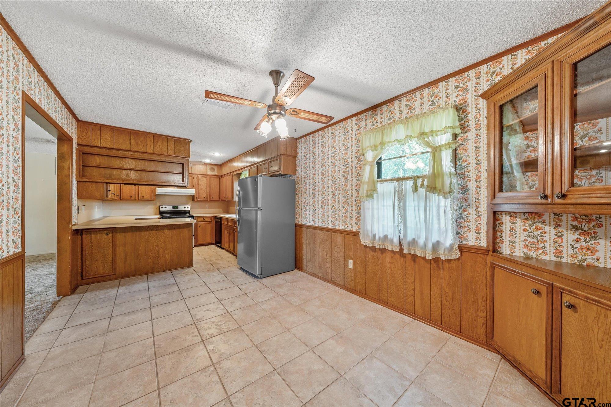 13791 Maple Drive Tyler, TX 75709 - Photo 10 of 26 a kitchen with stainless steel appliances kitchen island granite countertop a refrigerator and a stove top oven