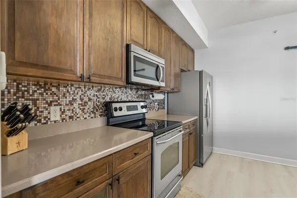 a kitchen with stainless steel appliances a refrigerator a stove and a sink