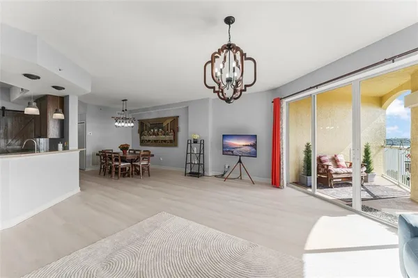 a view of livingroom with furniture wooden floor chandelier